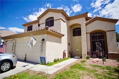 Mediterranean / spanish-style house featuring a ga