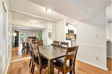 Dining area featuring baseboards, light wood-type 