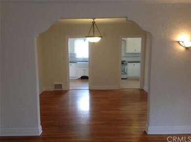 Formal dining room view and kitchen beyond.