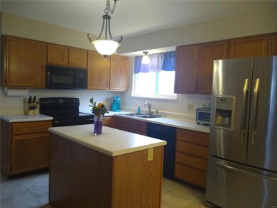 The kitchen has center island, lots of cabinets co