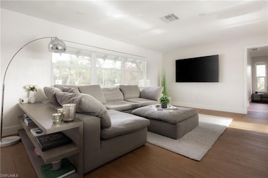 Living room with wood-type flooring