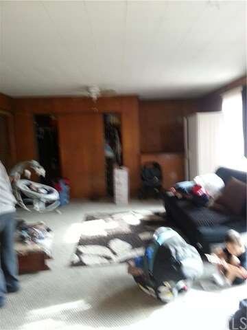 Living room with closet, and bar.