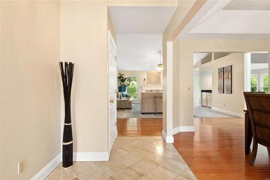Entry foyer opens to dining room with hardwood flo