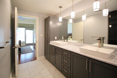 Two sinks on a marble counter top with gorgeous li