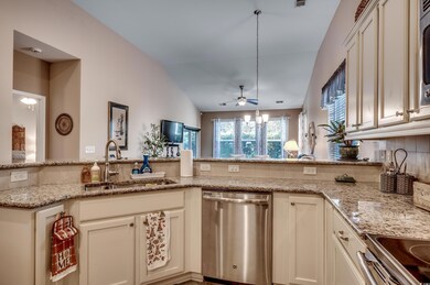 Kitchen featuring light stone countertops, sink, s