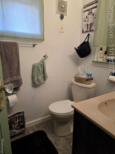 Half bathroom with vanity and toilet