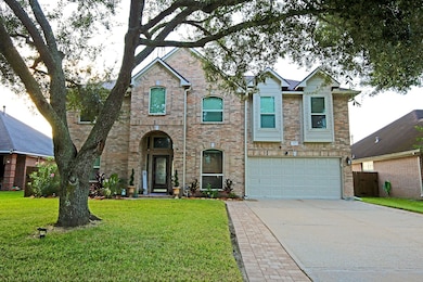 Welcome to this charming two-story brick home with a double garage, nestled in a well-maintained yard. The house has a welcoming entrance with arched windows and tasteful landscaping.