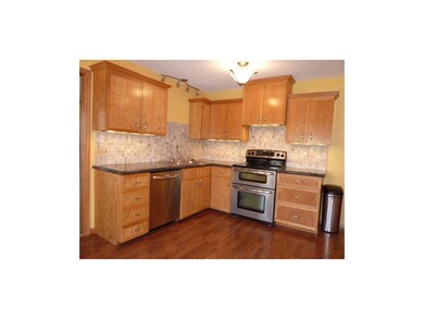 Gorgeous kitchen has custom cabinetry, granite cou