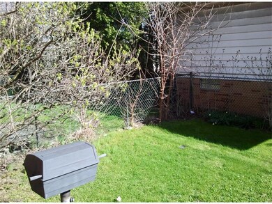 Fenced in yard with built-in gas grill.