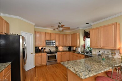 Kitchen with stainless steel appliances, breakfast bar and walk-in pantry.