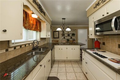 Kitchen with granite counter tops, tile floors and