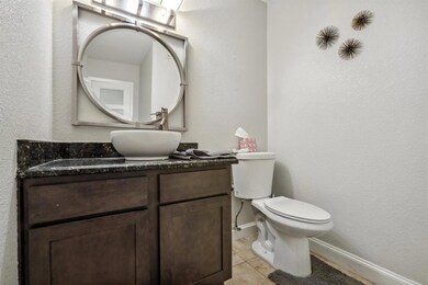 Half bathroom with tile patterned flooring, vanit