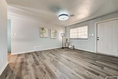 Living room with laminate flooring, all new paint,
