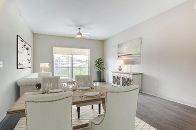 Living room featuring light wood-type flooring and ceiling fan