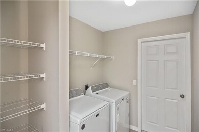 Laundry area featuring independent washer and dryer and baseboards