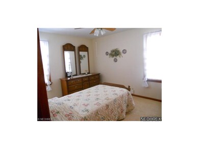 Notice the neutral walls and carpeting in the spacious bedroom.