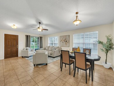 Tiled dining area featuring a textured ceiling and