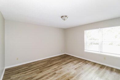 Empty room with light wood-type flooring and baseboards