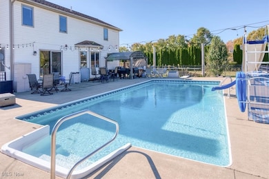 View of swimming pool with a patio and a water slide