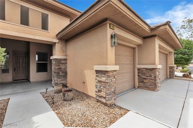 Doorway to property featuring stone siding, a gara