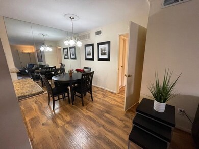 Dining area features laminate-wood flooring. A lar