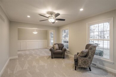 Living room opens to dining room. 3 large windows 