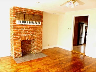 Living Room. Exposed brick fireplace with gas line
