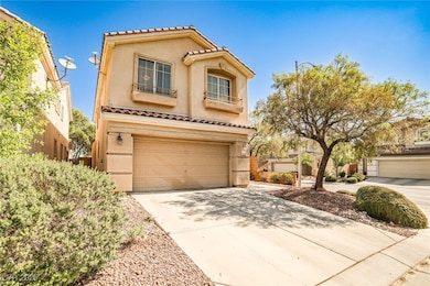 View of front facade featuring a garage, stucco si