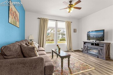 Living area featuring baseboards, wood finished fl