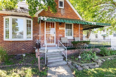 View of front facade with brick siding and a porch