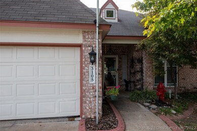 Curved sidewalk leads to covered entry.