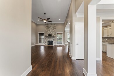 Inviting entry way into open floor plan with beautiful brick fireplace.