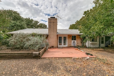 Rear view of property with french doors