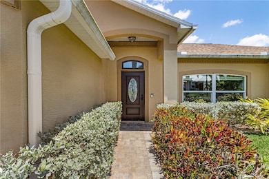 Property entrance with stucco siding and roof with