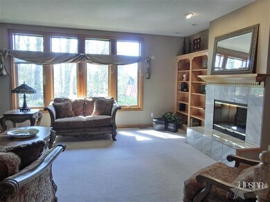 Great room with large windows and built ins