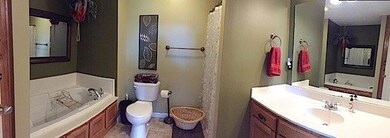 The Master bath with a whirlpool tub, stand alone shower, and linen closet.