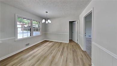 Unfurnished dining area with a textured ceiling, l