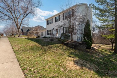 Colonial-style house with a front lawn
