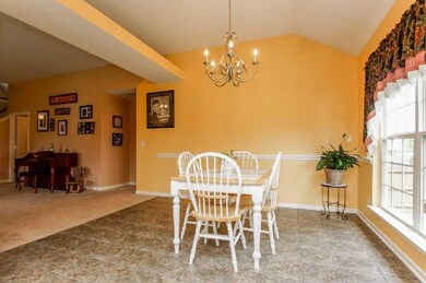 Spacious Dining Area with vaulted ceiling and tile floors