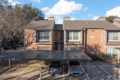 Back of property with a chimney, brick siding, and