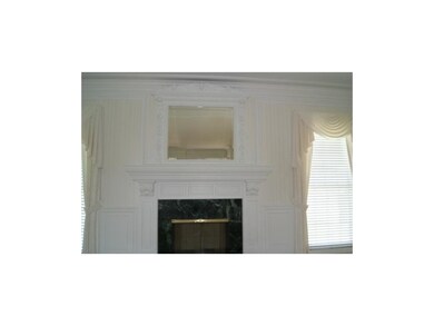 Intricate fireplace mirror and mantel in the great