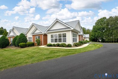 View of front of house with a front yard, brick siding, and a shingled roof