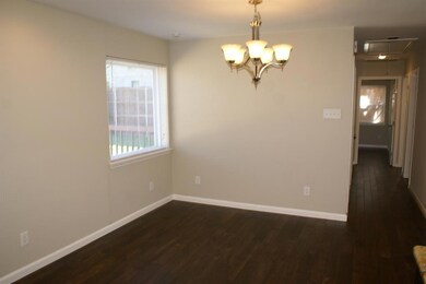 Dining room with its upgraded lighting fixture ope