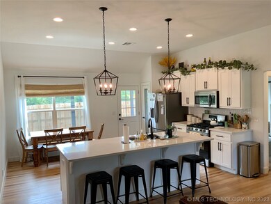 Kitchen open to living with bar seating.