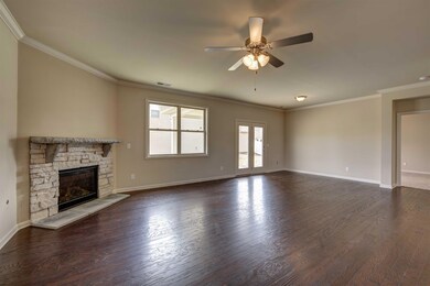 View from kitchen into open, oversize living room.   All photos of a similar home, not of the listed property.