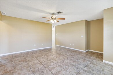 Unfurnished room featuring ceiling fan and light tile floors