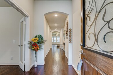 Welcome your guests into a wide hallway with offic