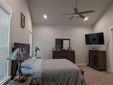 Carpeted bedroom with baseboards, a ceiling fan, recessed lighting, and lofted ceiling