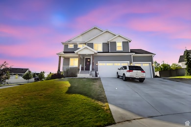 View of front of home with concrete driveway and an attached garage