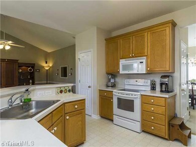 Kitchen. The well-appointed kitchen with big stainless steel sink, smooth-top range, built-in microwave also has lots of cabinet and counter space.
